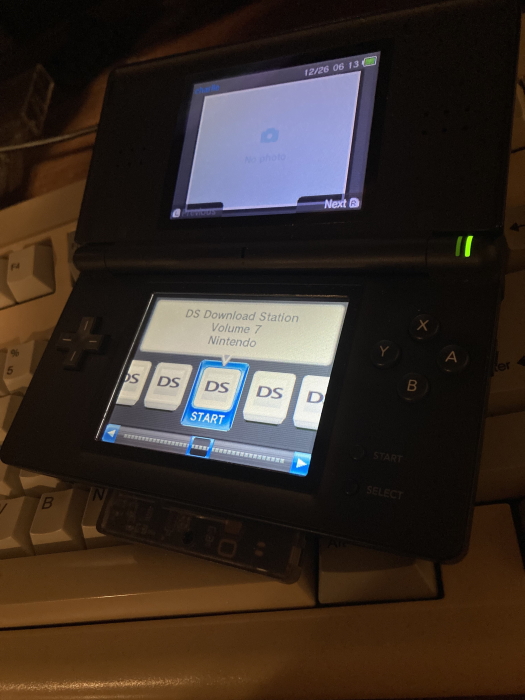 Picture of the same physical DS, now with properly titled Download Station ROMs. A ROM titled 'DS Download Station Volume 7', published by Nintendo, is selected.